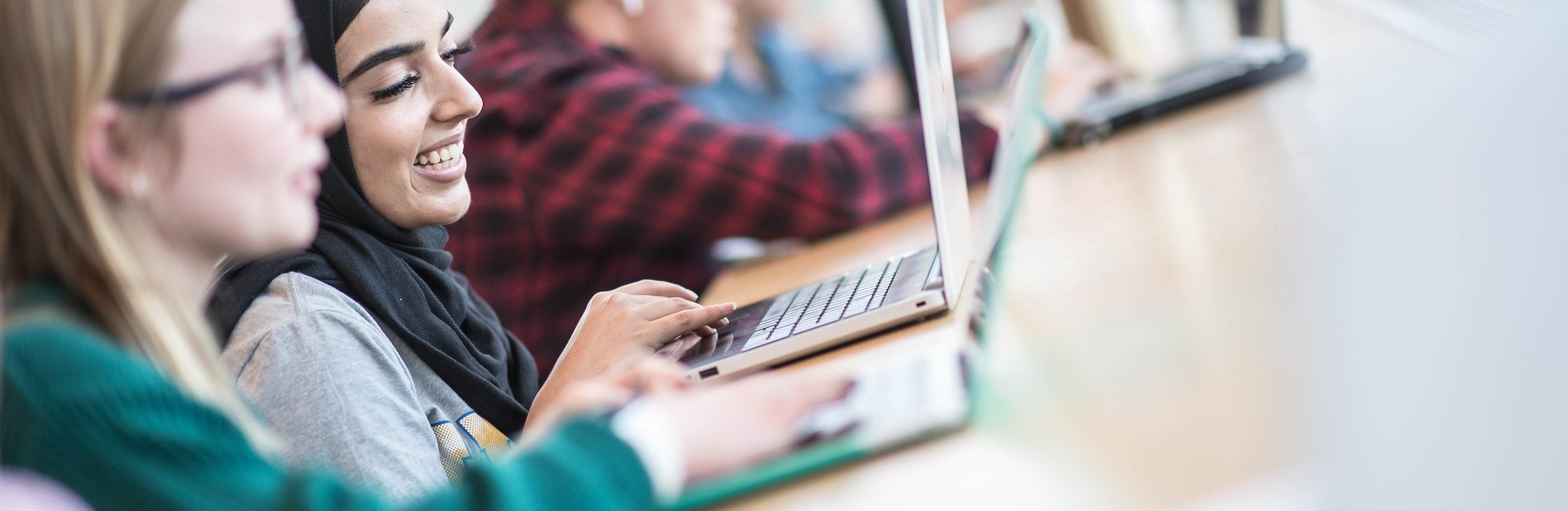 Two UBC students working on their laptops